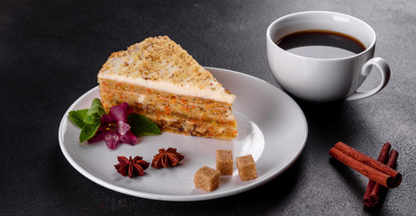 Fresh delicious carrot cake with cream on a dark background