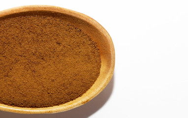Instant chicory in a wooden spoon on a white background close-up. Isolate. Top view. Flat lay. Macro of chicory.