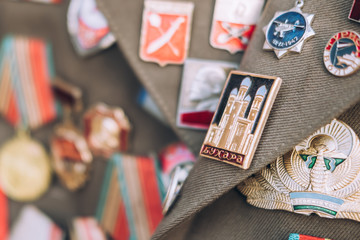 Lapel old metal badges on a jacket. Bukhara badge