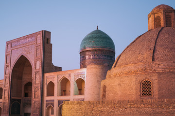 Middle Asia. Uzbekistan Bukhara. Summer. Eastern mosque. Poi Kalyan complex. Mosque in lilac shades from the sunset
