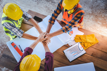 The top view of the team of construction engineers and three architects at the meeting demonstrated...