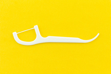 dental floss on yellow background. - obrazy, fototapety, plakaty