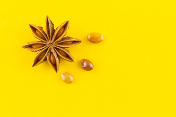heap star anise top view on yellow background.