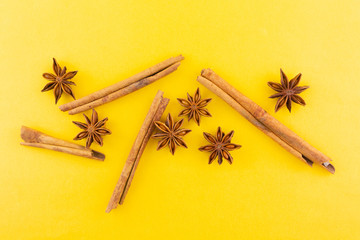cinnamon and star anise on yellow background.