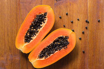 Papaya fruit on wooden background.Slices of sweet papaya on wooden background,Halved papayas