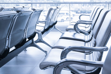 Row of empty seats in airport lobby,An empty row of chair at airport