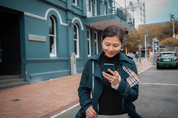 Woman using smartphone on Wellington city street