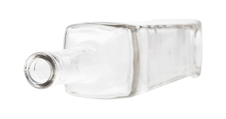 overturned empty clear wine bottle isolated