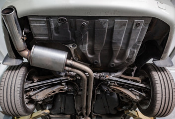 Close up of car exhaust system pipe at the garage, automotive car service