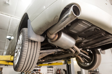 Close up of car exhaust system pipe at the garage, automotive car service