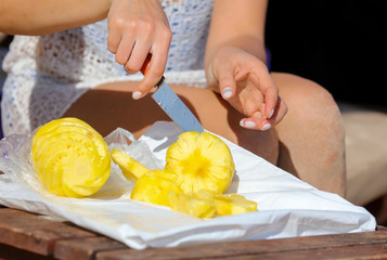 Knife sliced pineapple on a table.