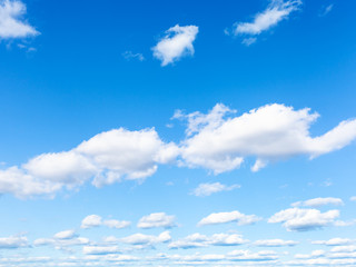 blue sky with white cumulus clouds on sunny day