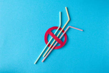 Plastic pollution, stop sign. Plastic caps, tubes on a blue background, minimalism. Recycling plastic, reusable packing, sorting garbage concept. Zero waste, ecology. Copyspase,