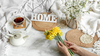 Spring still life with a Cup of tea and flowers .