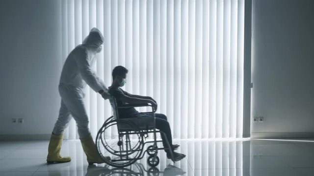 Young man on wheelchair with his doctor