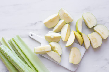 fresh green apple and celery on marble table