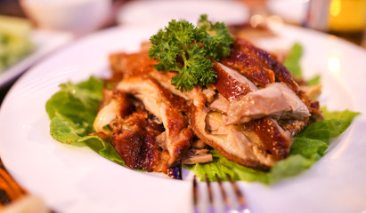 Peking duck in a plate on the table.