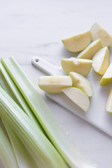 fresh green apple and celery on marble table