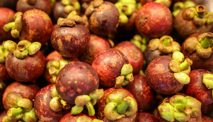 Garcinia mangostana fruit in a shop window in a market.