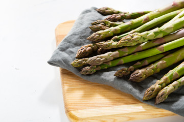 Fresh green asparagus close up on cutting board