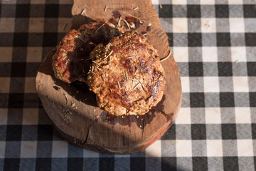 Steak beef hamburg on chopping board on grid pattern table