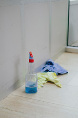 Obraz na płótnie Canvas Cleaning equipment with a spray bottle and a rag that lies in a hallway and was forgotten by the cleaning staff after cleaning the house