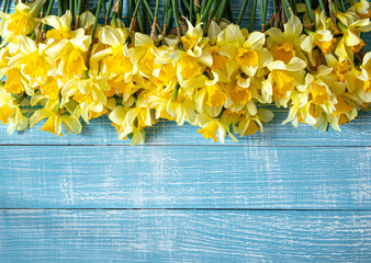 Beautiful spring flowers and blooms on a wooden background.