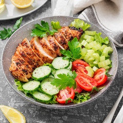 Grilled chicken breast, fillet and fresh vegetable salad. Healthy lunch menu.