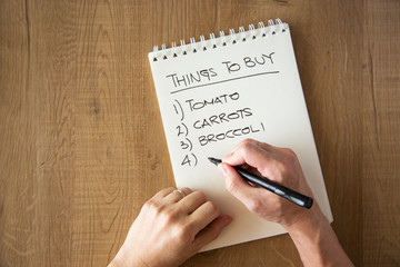 hand writing a shopping list