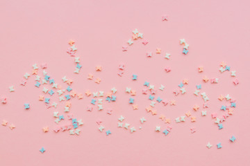 sprinkles background, sugar sprinkle butterflies, decoration for cake and bakery. Top view, flat lay. pastel colors.