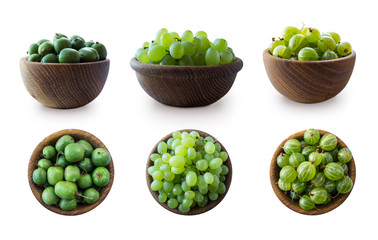 Green fruits isolated on a white background. Collage of different fruits and berries at green color.Green baby kiwi fruit actinidia, gooseberry, green grapes in a wooden bowl. Fruit and berry on white