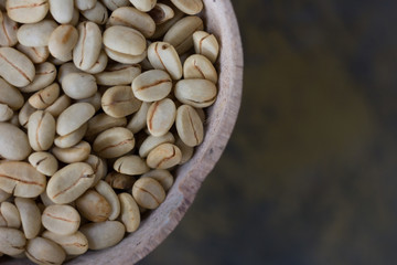 White coffee beans on old rusty background