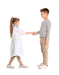 Cute little doctor with patient shaking hands on white background