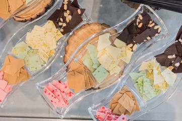 Thin slices, small pieces of colored artisan homemade chocolate