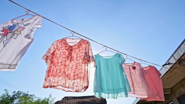Clothes hanging on the clothesline sterilized in the sun to prevent coronavirus