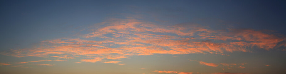 Fototapeta premium Abstract orange clouds at sunset sky background. Panorama style background
