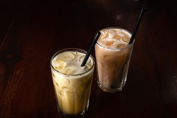 Banana and kiwi cocktail with ice on a wooden background