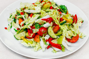 fresh vegetable salad with Beijing cabbage tomatoes and herbs, close-up