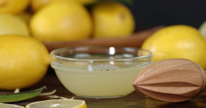 Fresh squeezed lemon juice in a bowl slowly rotates.