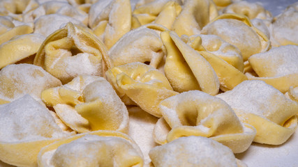 Delicious tortellini a ring-shaped pasta from Italy. Traditionally they are stuffed with a mix of meat, parmigiano reggiano cheese, egg and nutmeg