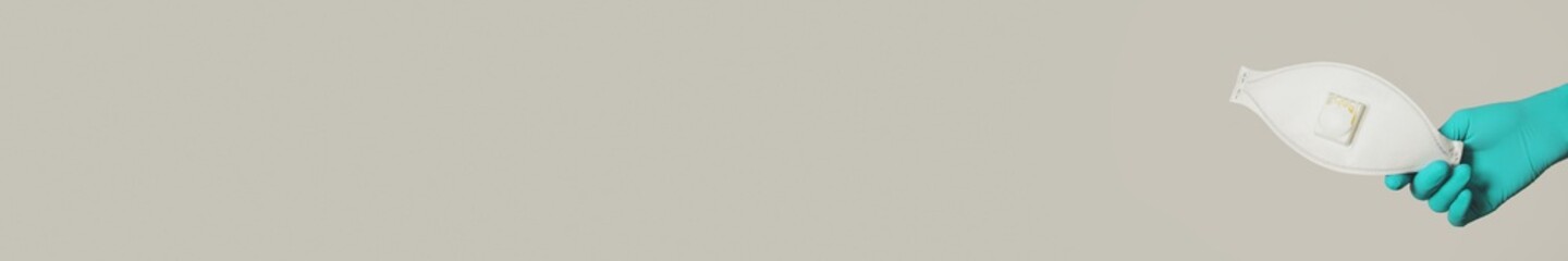 Medical face mask on gray banner background with copy space