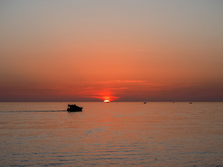 Pleasure boat against the backdrop of a beautiful sea sunset