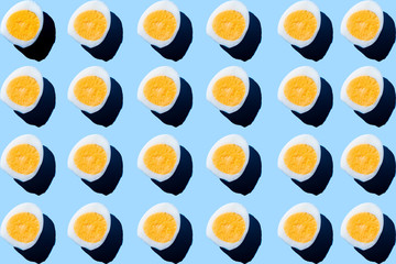 Pattern made of eggs on pastel blue background. Minimal food concept.