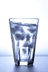 glass filled with ice water on a white background