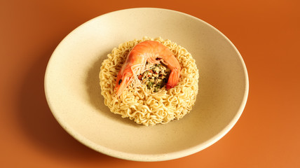 Spicy instant noodle soup with shrimp. shrimp soup, cooking, food. Raw dried circle-shaped vermicelli in a plate. Asian food. pasta, for the preparation of which it is enough to pour boiling water