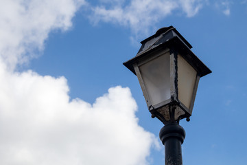 Fototapeta na wymiar Classic lantern and a blue sky with clouds