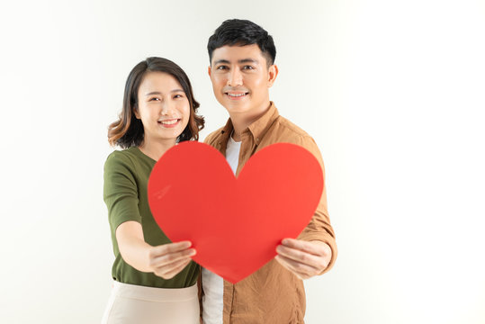 Bright picture of beautiful couple holding big heart