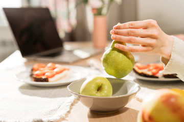 Young woman hand holding pear