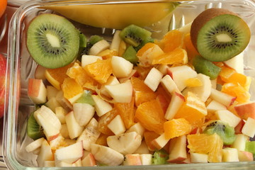 Obraz na płótnie Canvas delicious fruit salad with banana, kiwi, apple and orange