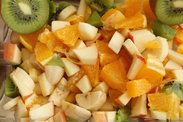 Fototapeta na wymiar delicious fruit salad with banana, kiwi, apple and orange